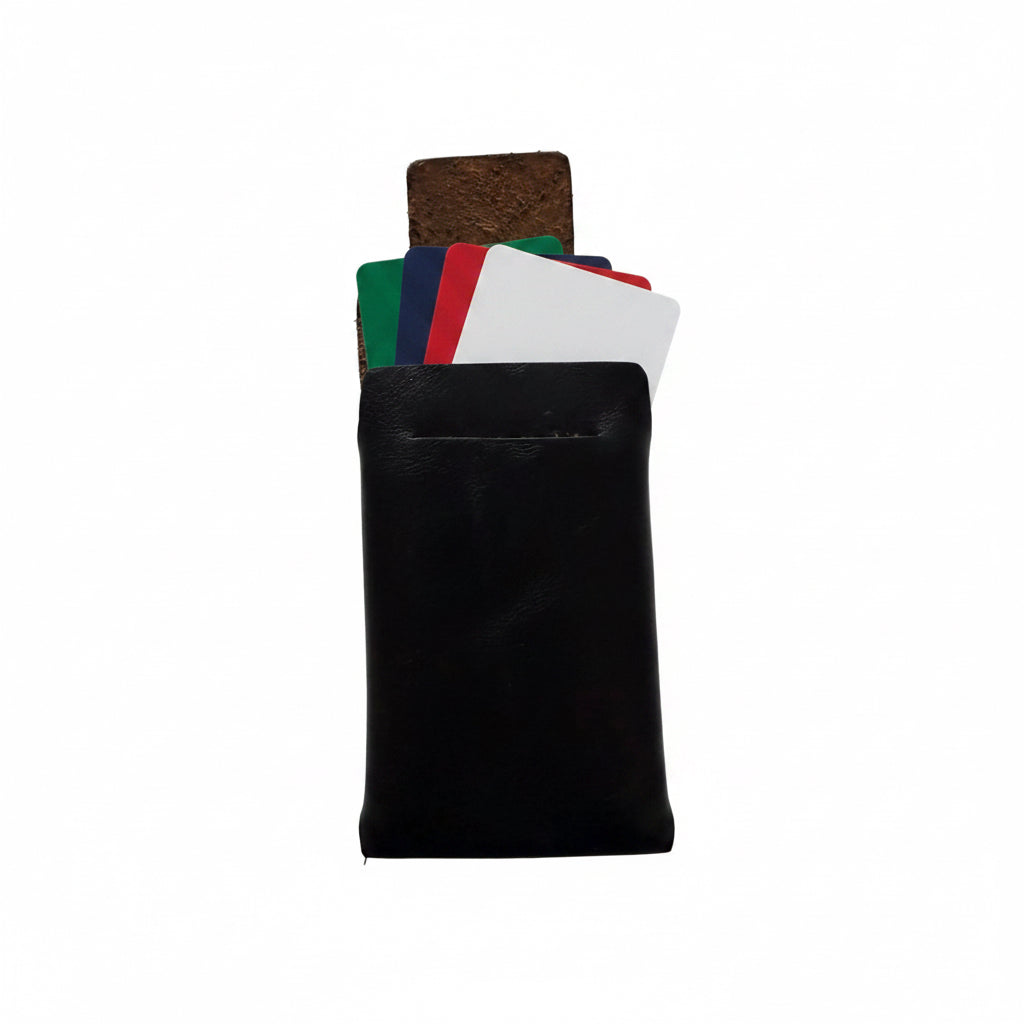 A minimalist black leather card holder wallet with several cards partially pulled out, showing a brown textured card underneath, set against a plain white background.